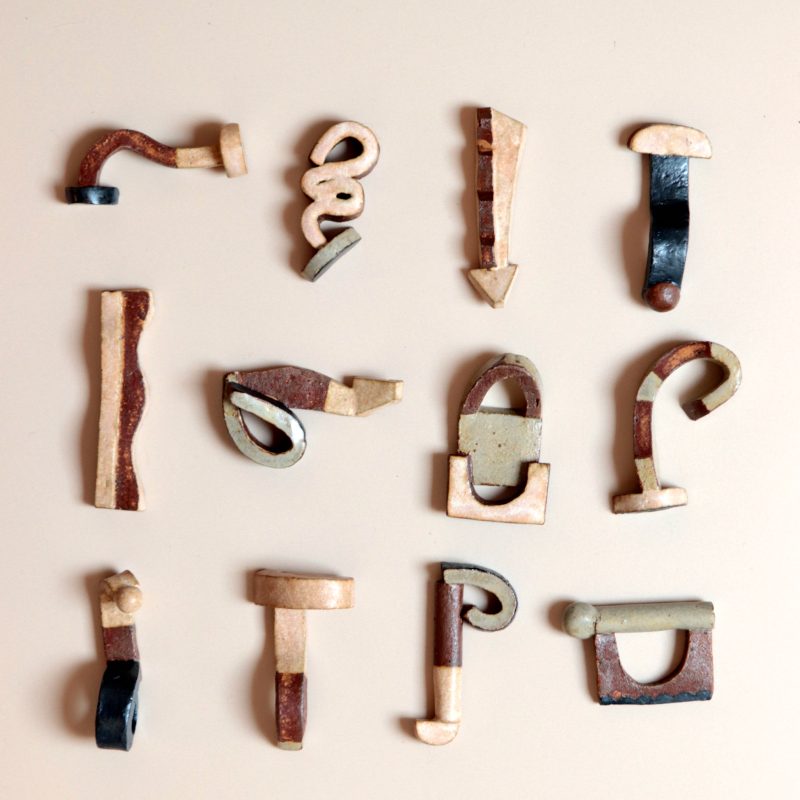 Cream coloured slipware plate with brown geometry lines/shape glazed on