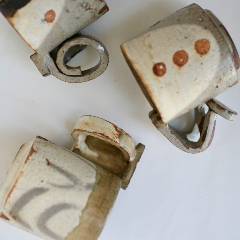 brown, beige and off-white ceramic mugs in geometric shapes