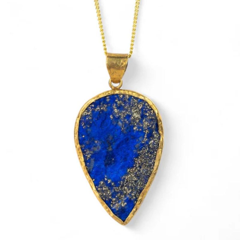 A pendant consisting of an upside-down teardrop shaped blue lapis lazuli stone with flecks of gold iron pyrites, set in a rough gold surround