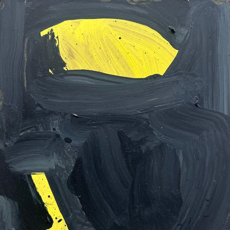 A crouching figure in yellow and black.