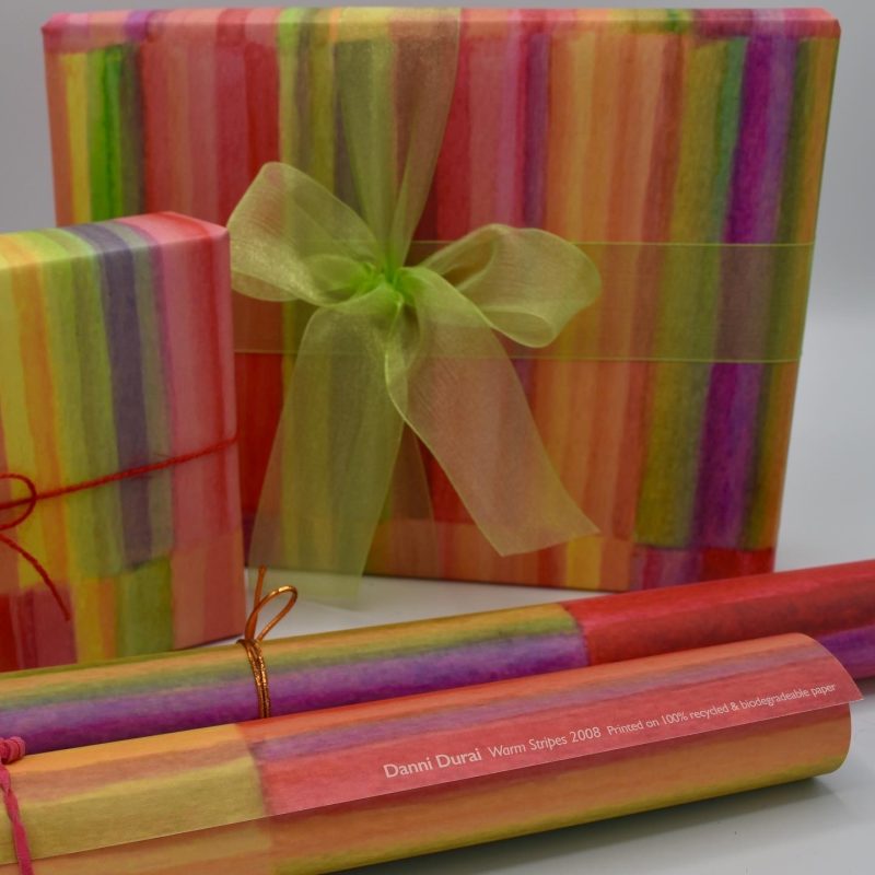 Colourful wrapping paper printed from an abstract watercolour painting in stripes of warm colours - red, pink, orange, yellow and light green
