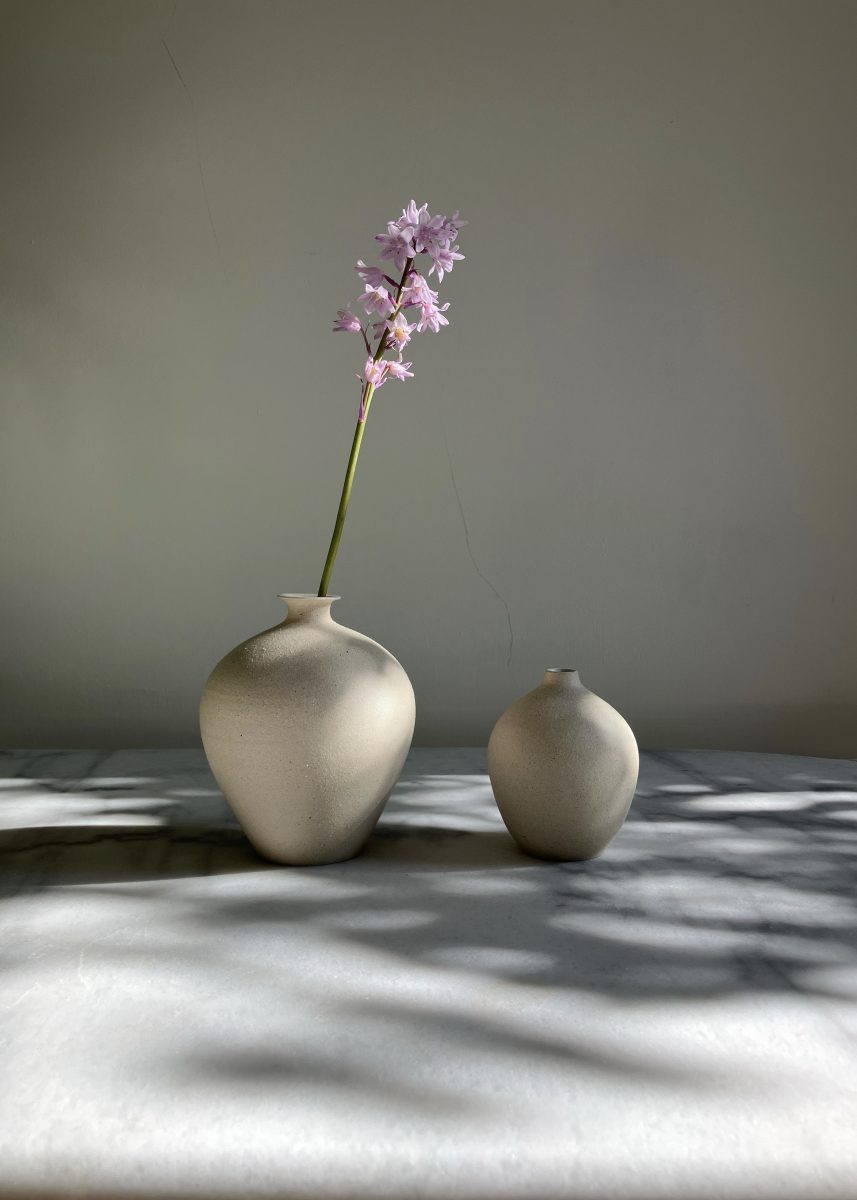 two stoneware vases on a marble table