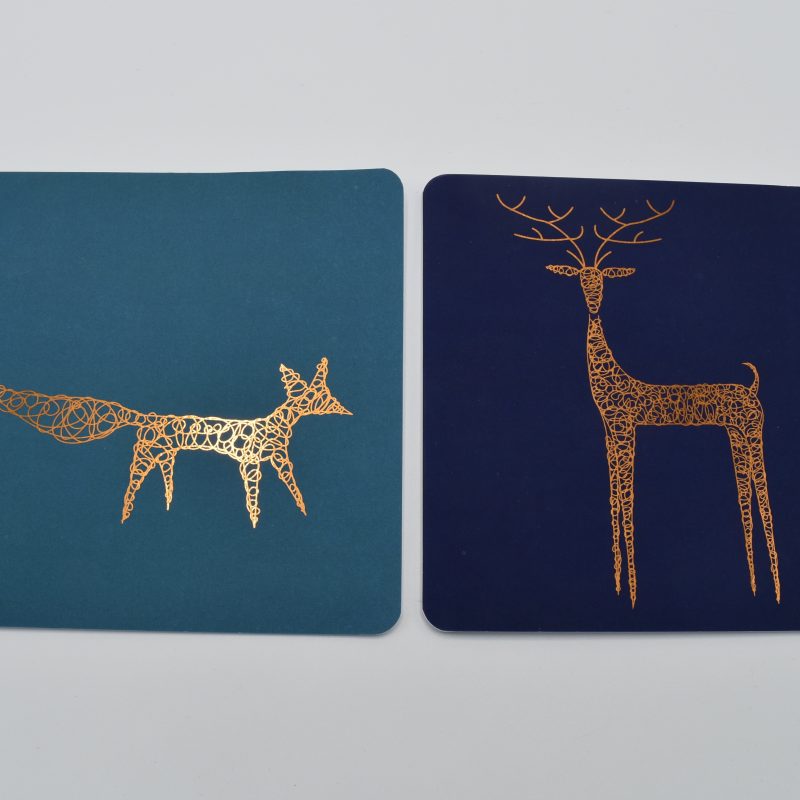 Foiled Christmas cards with a plain background and copper foiled fox on one and a deer on the other