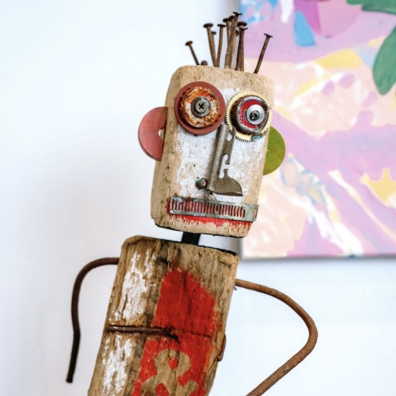 Standing figure with dog made from repurposed materials; wood, metal, wire