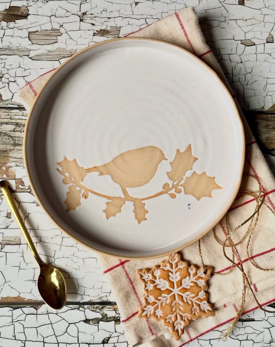Stoneware ceramic plate with white glaze and robin on holly branch motif