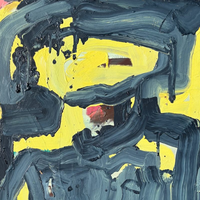 A figure in yellow and dark blue/grey.