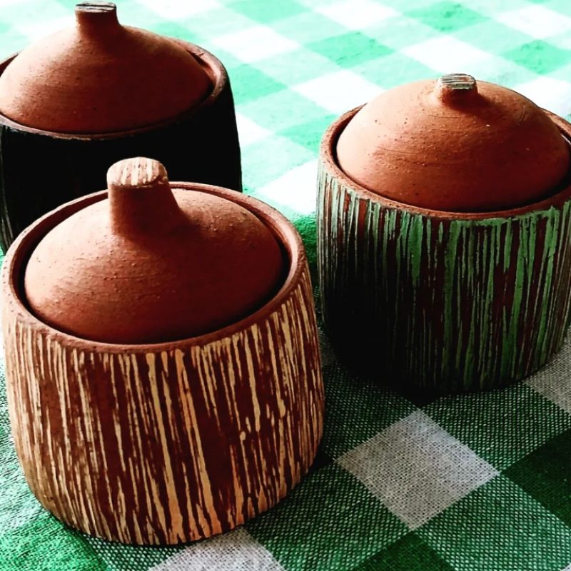 Three lidded pots in terracotta clay and slip decoration