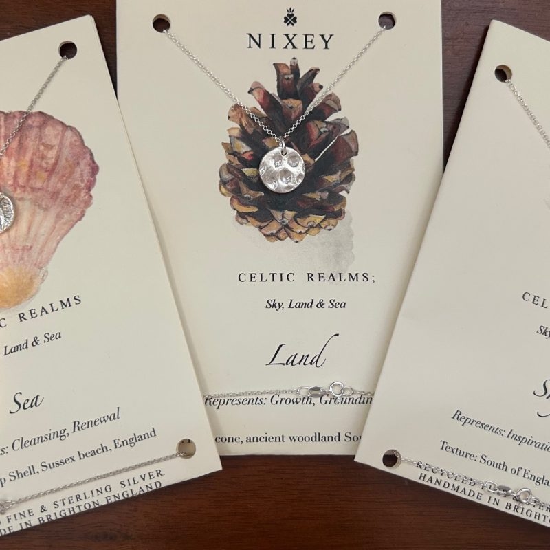 Three small silver nature pendants, embossed with the print of a pine cone, a sea shell and a feather