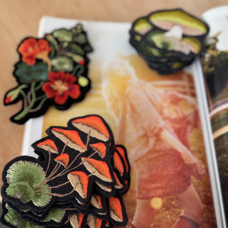 Freehand machine embroidered miniature artwork patches.