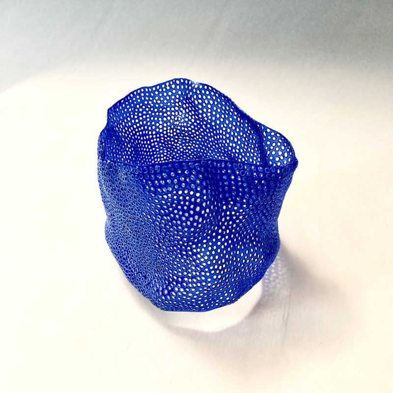 Plastic bottle refashioned into an organic large cuff bangle. Hundreds of holes individually punctured into it, evocative of sea coral