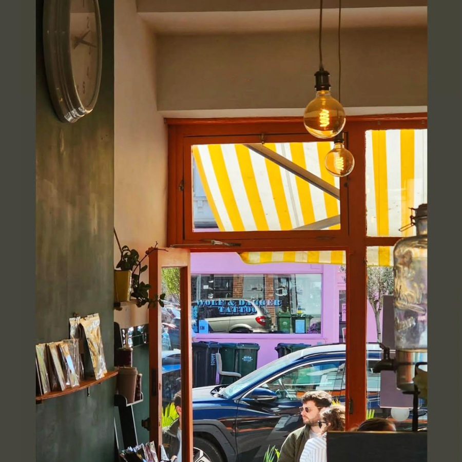 Atmospheric image of the interior of the café showing a luminous outside street view.
