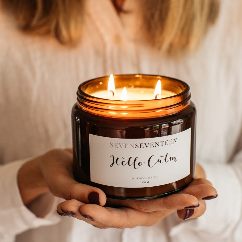 Someone showing a large candle burning with 3 wicks