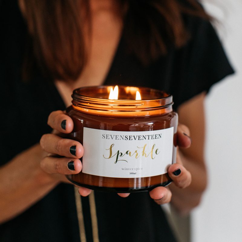 An image showing a large candle with 3 wicks being held