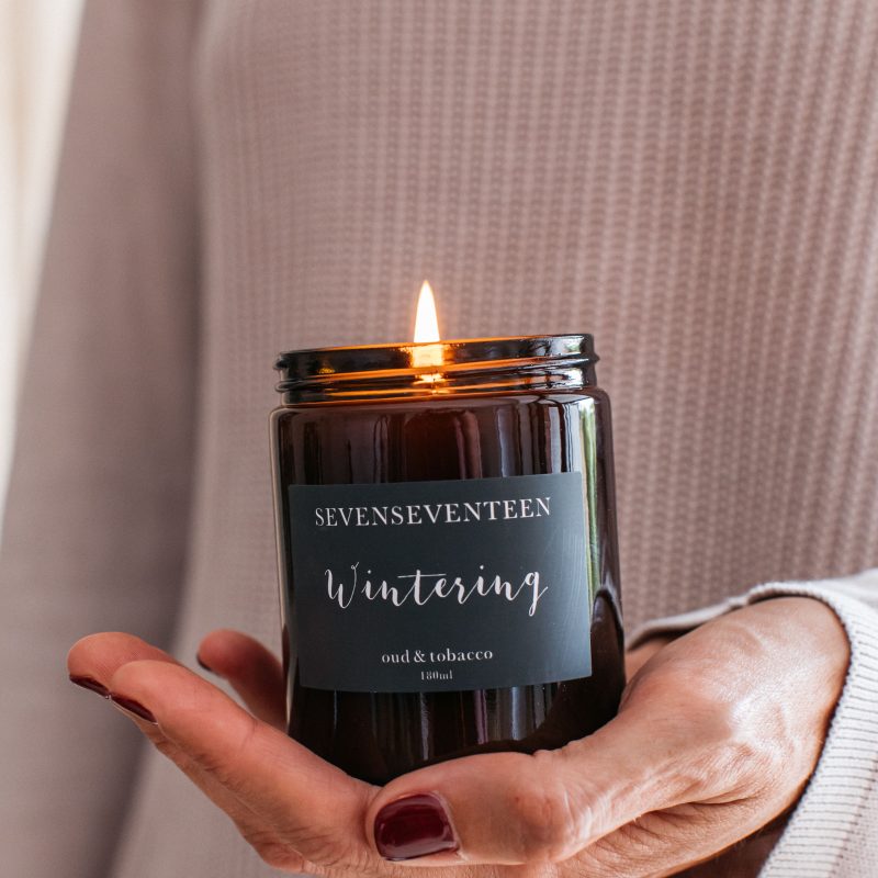 Someone holding a lit candle