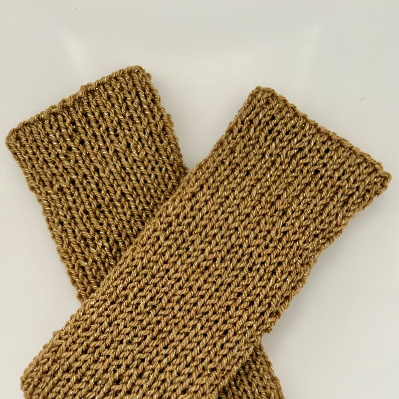 Hand knitted wrist warmers in gold flecked ochre acrylic wool