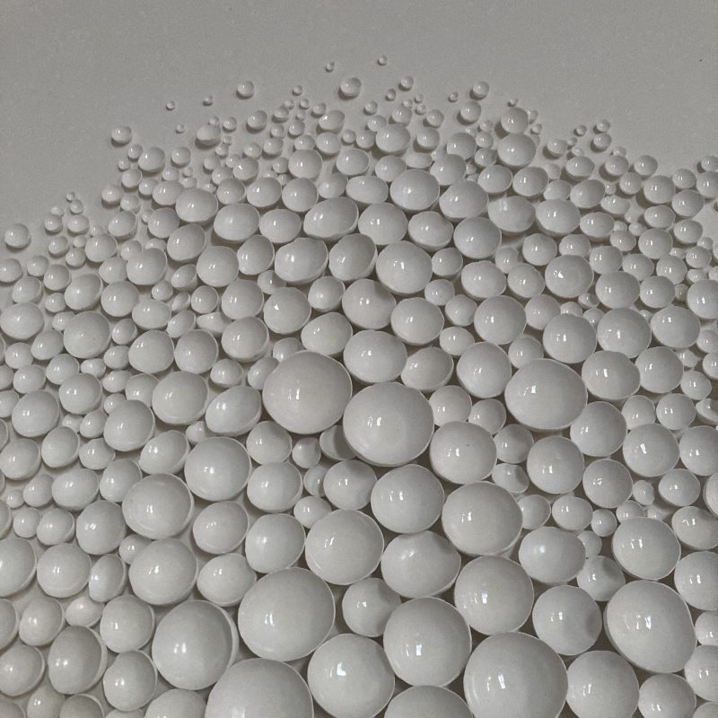 Miniature hand made clay vessels arranged in organic formation and framed. Atmospheric