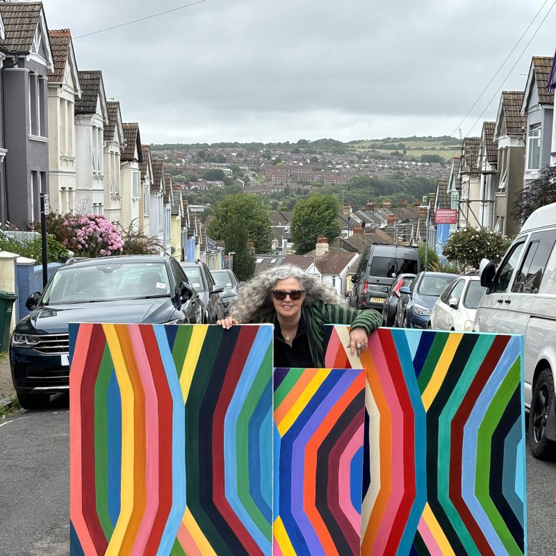 The artist in the street with 3 stripes large paintings 