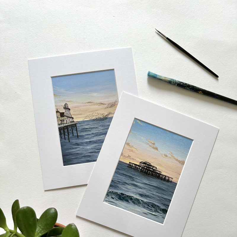 Emma Christopherson - prints featuring the two Brighton piers at sunset