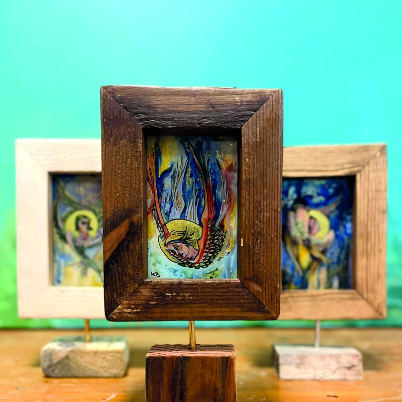A group of framed glass artworks depicting Seraphim