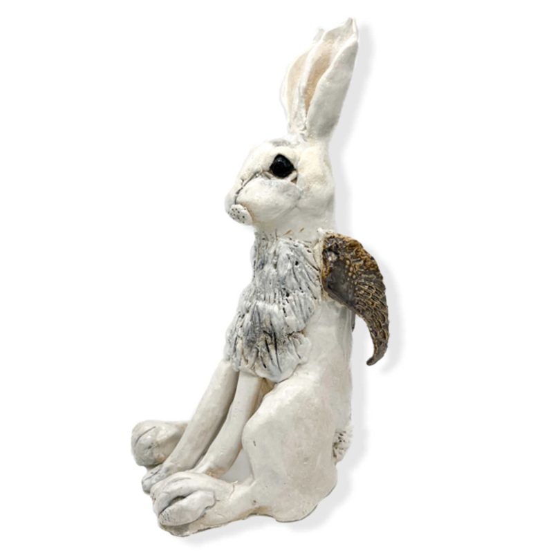 A beautiful white snow hare with golden wings ceramic sculpture