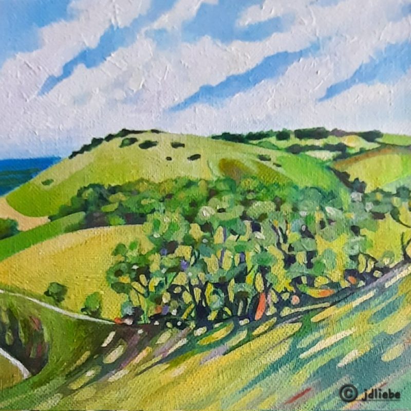 A patchwork of colours reflecting the light of the trees on the Sussex Downs. Green and yellows capture a perfect Summer’s day.