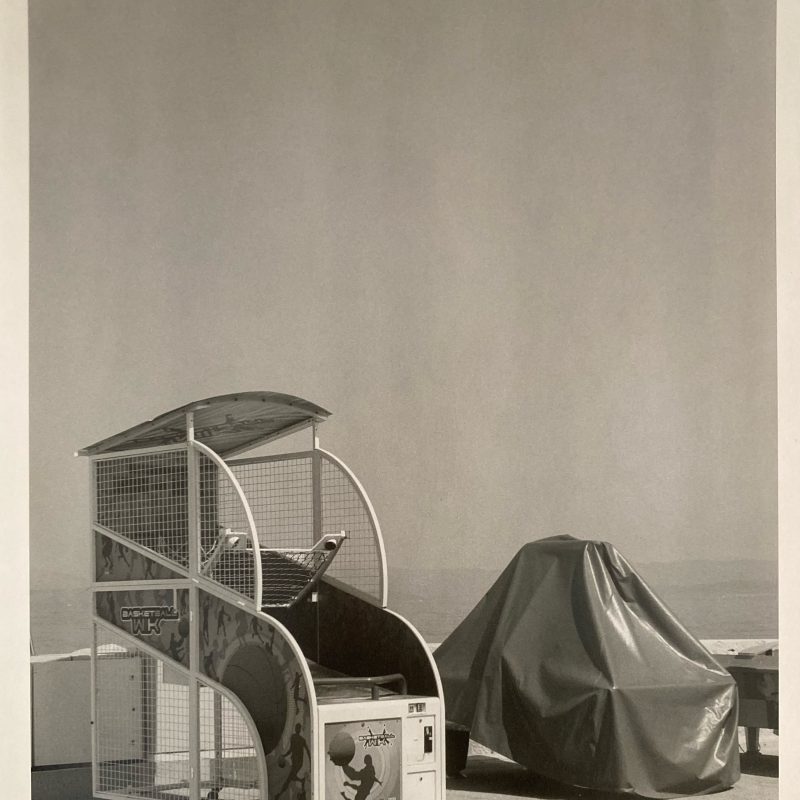 A scene at the beach of partly covered, beach gaming machines.