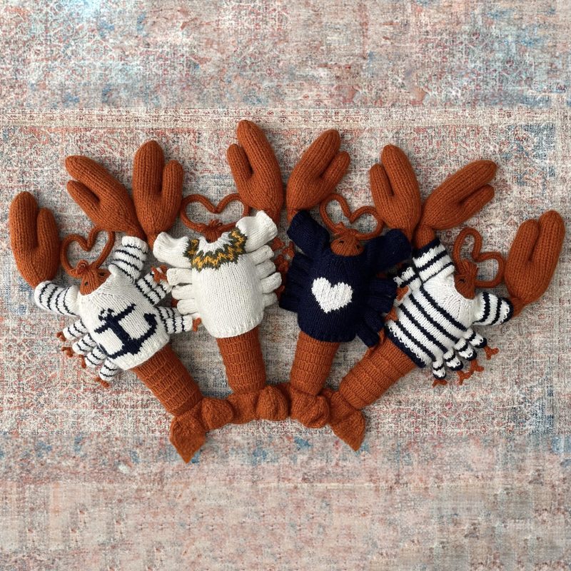 A knitted lobster and knitted crab wearing sweaters