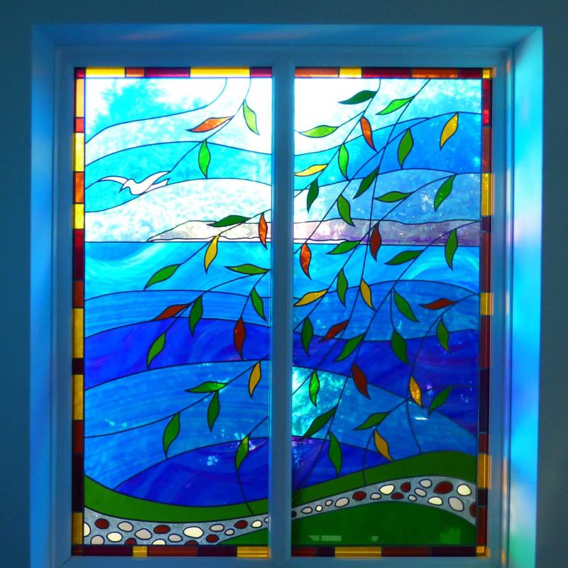 glass work of a window view in blues and greens