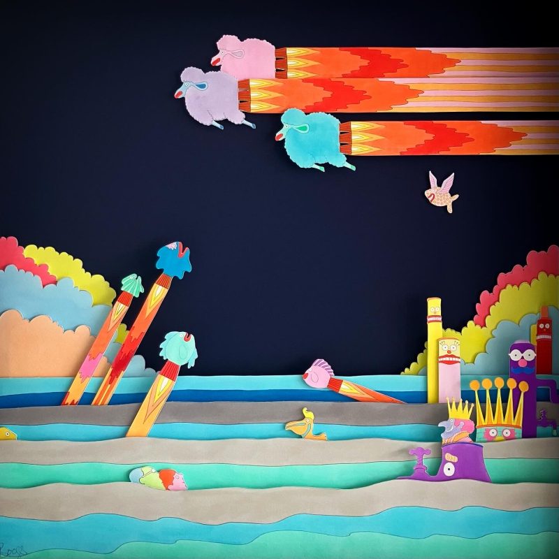 A hand-drawn and colour illustrated diorama featuring flying sheep and fish, made of layers of Giclée prints mounted in a box frame.