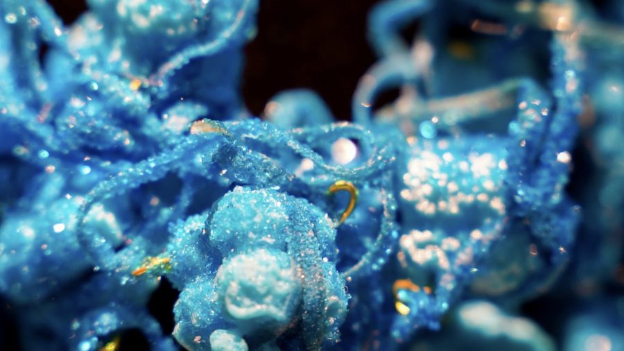 A necklace made from 3D printing with copper sulphate crystals resembling biological structures