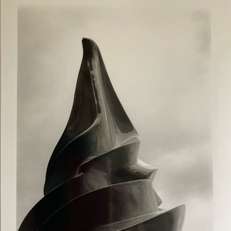 A giant fibreglass ice-cream statue photographed against a strong sun.