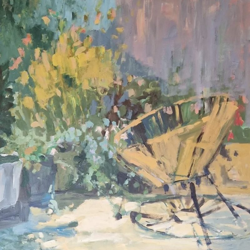 Green and yellow foliage greets yellow string chair in a calming garden environment