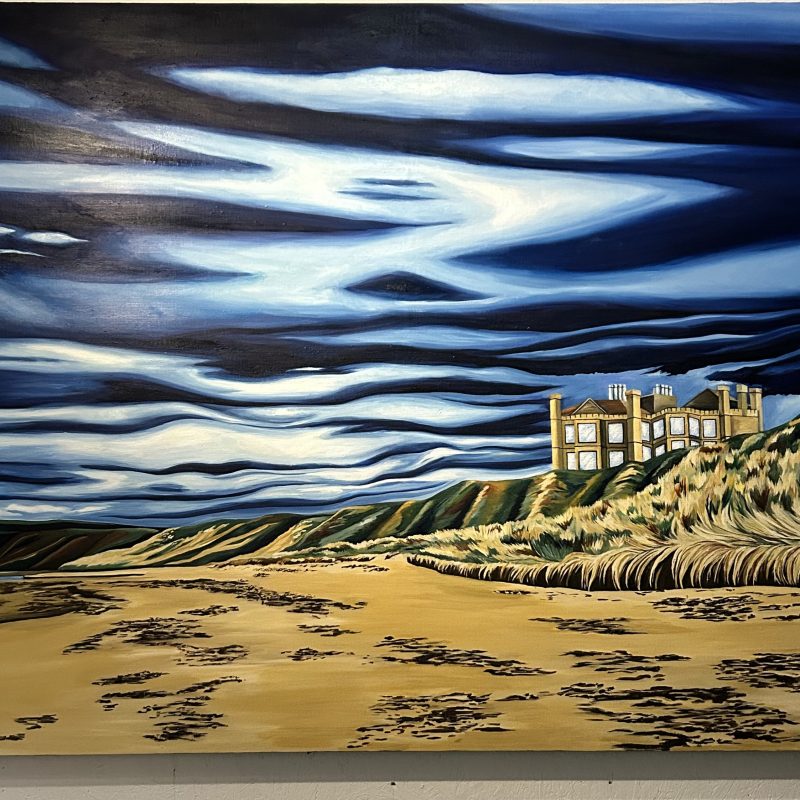 A large scale, colourful painting of rolling blue and cloudy skies over a vast sandy beach. 