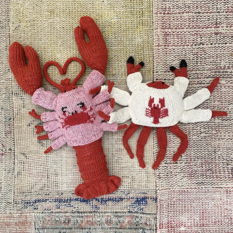 A knitted lobster and knitted crab wearing sweaters