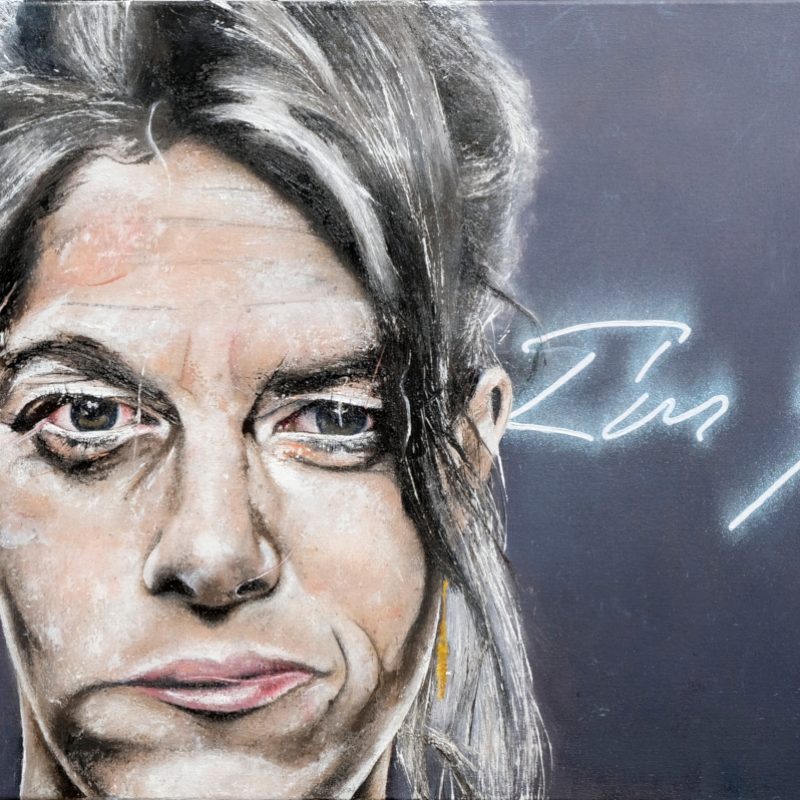 A portait of Tracey Emin, face-on. The paint has been applied with a palette knife and is somewhat stylised. On the wall behind can be seen a neon lit phrase of which only 