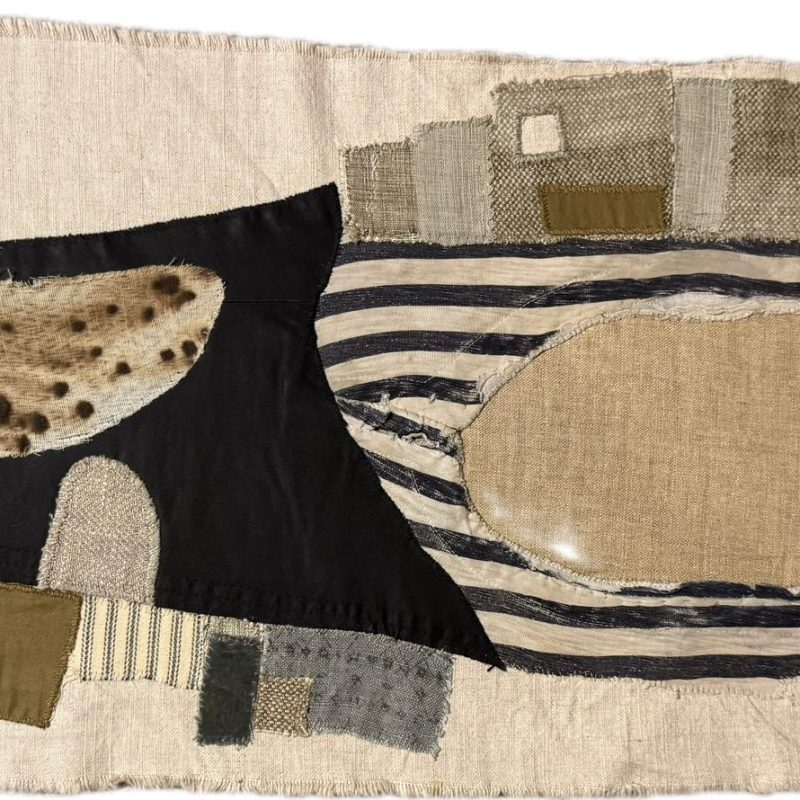 Abstract textile, landscape format. Tonal appliqué in greys, blacks and browns