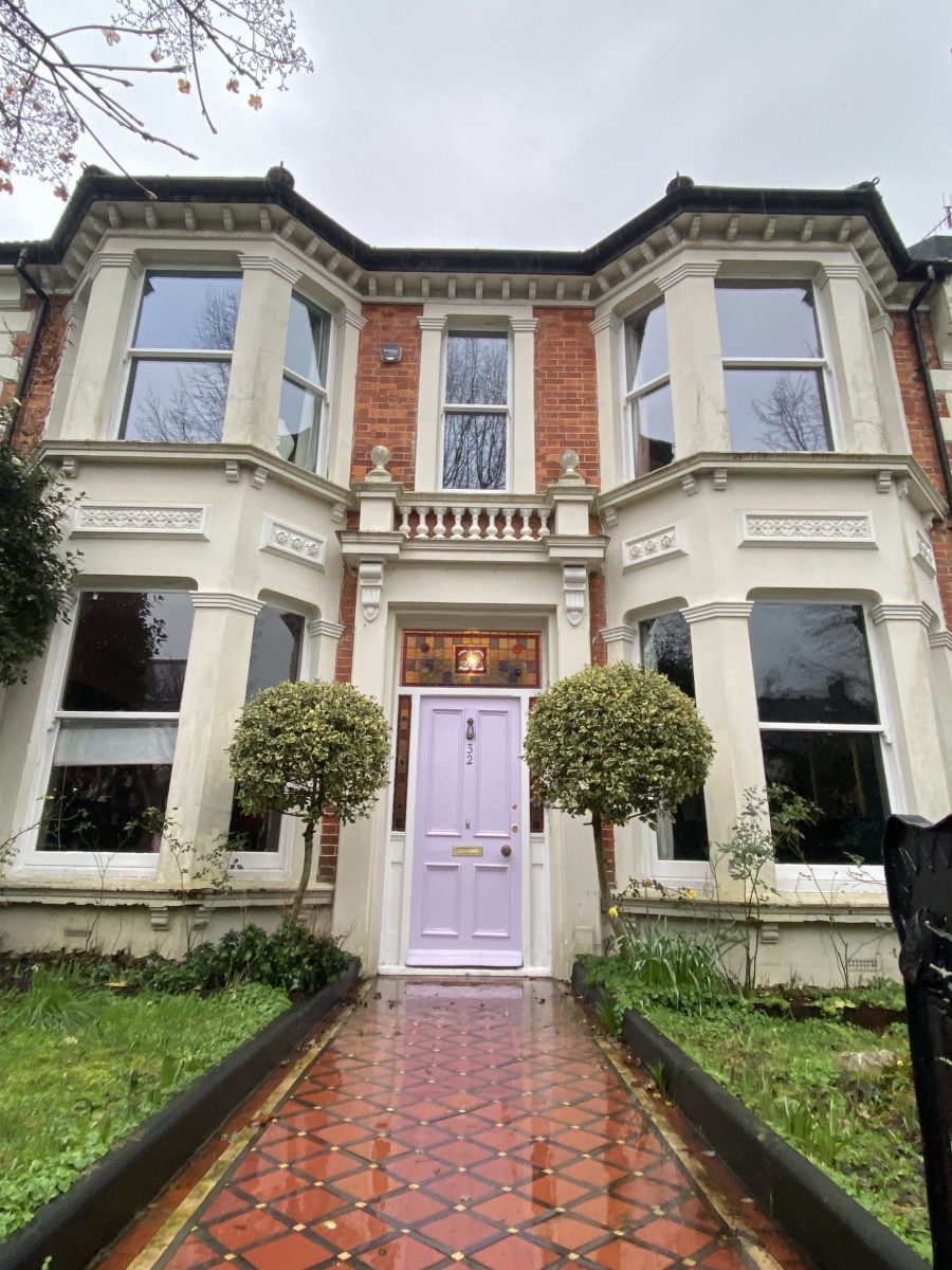 Image of red brick double fronted Victorian villa with lavender door