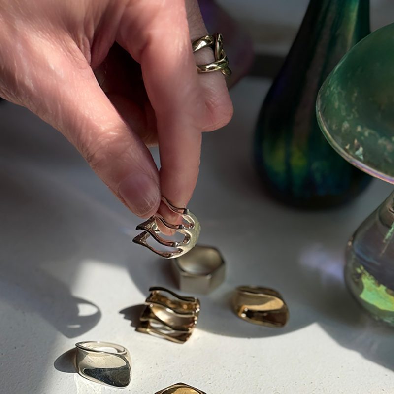 Hand picking up brass jewellery