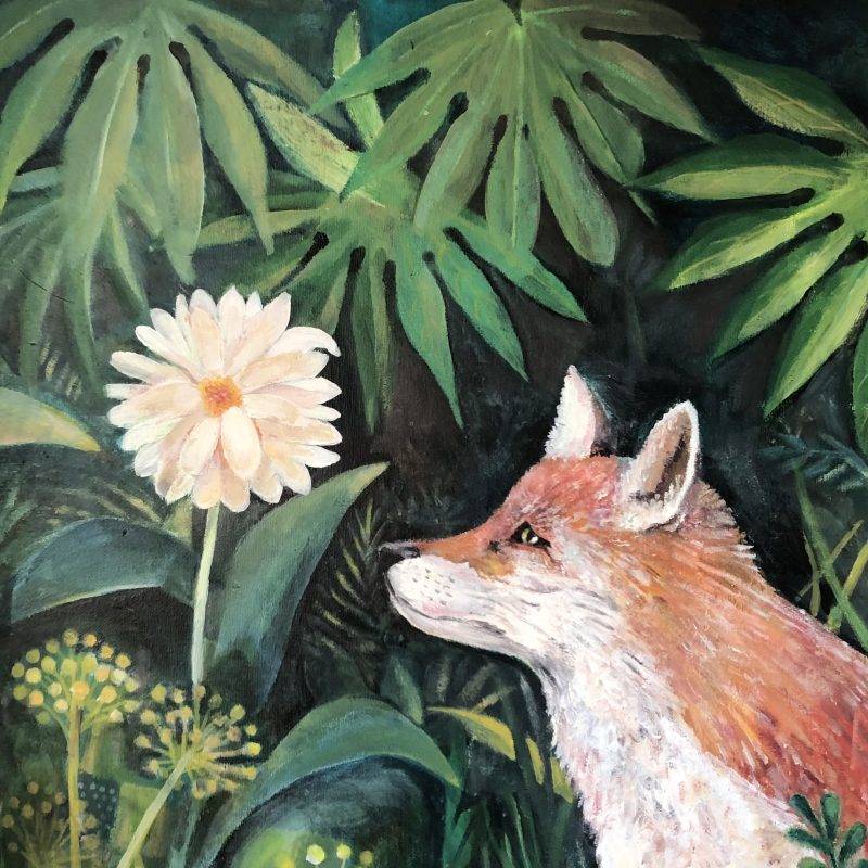 A fox smelling a garden flower at night