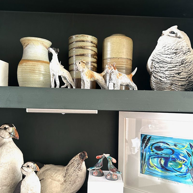 Ceramic birds and pots on shelf