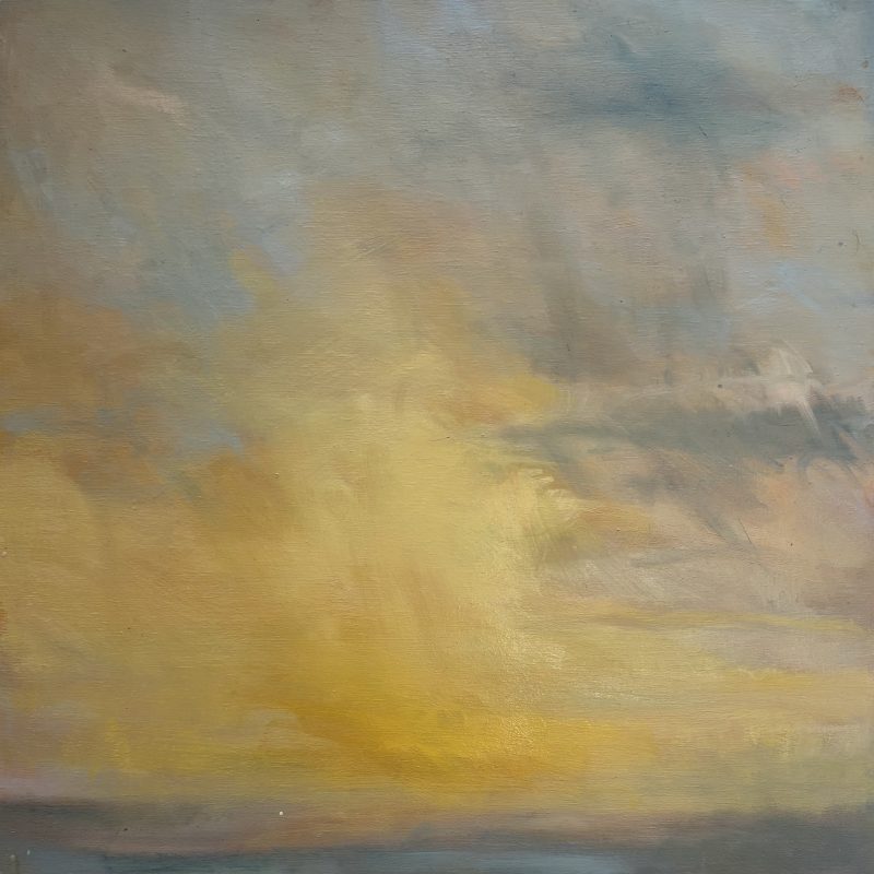 A shaft of yellow light over the sea at Brighton beach