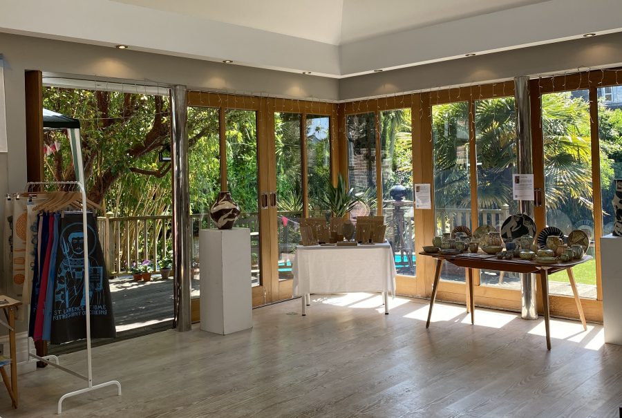 House kitchen with three artists displays of textiles, jewellery and ceramics