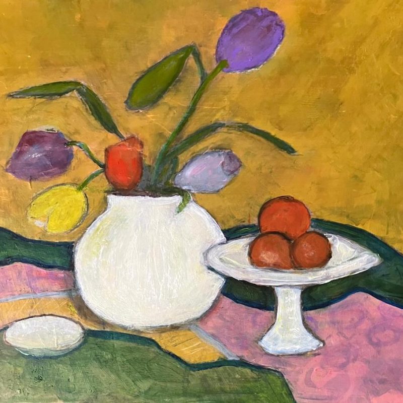 Colourful still life with fruit, white vase and tulips and fabric/landscape shapes in background.
