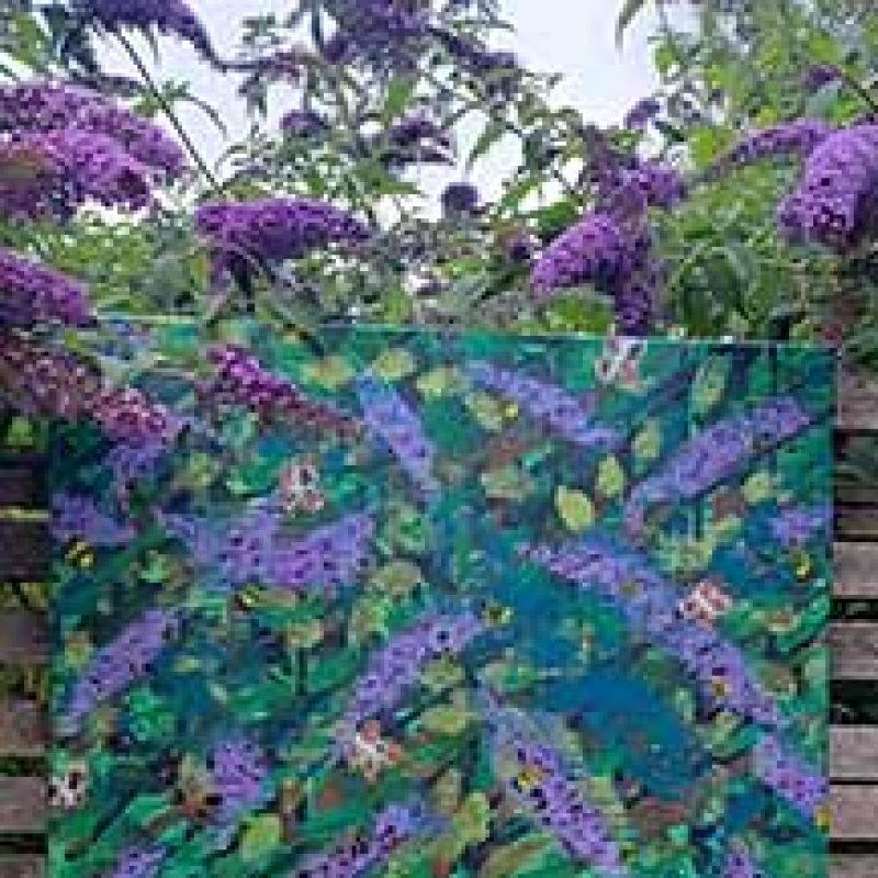 Lilac flowers against a brick wall in the garden