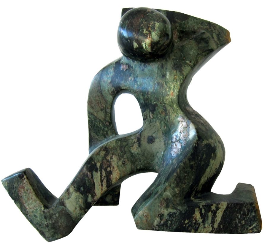 it is a stylised image of a foodballer made out of green serpentine stone with different green markings. Very dynamic, it shows the footballer kicking out his right foot.