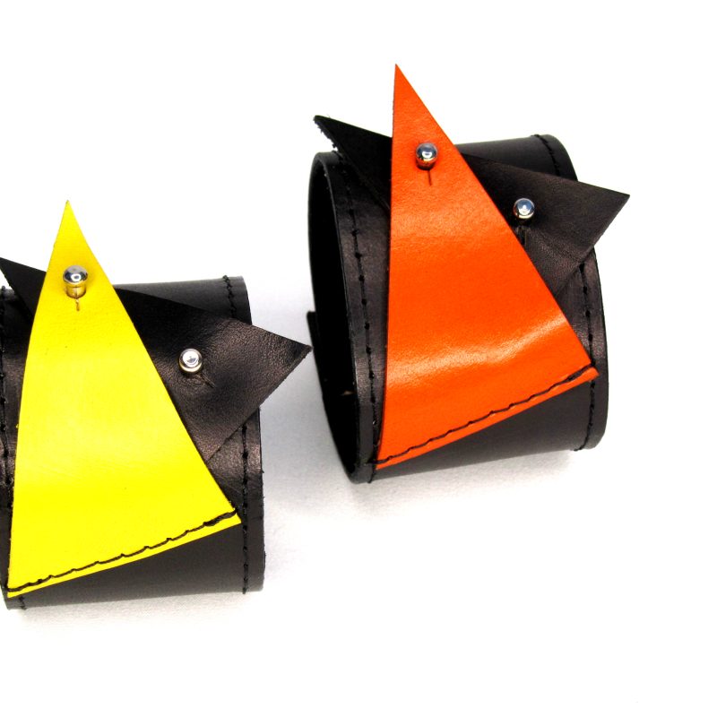 Leather cuffs with large triangle shapes in bright yellow and bright orange