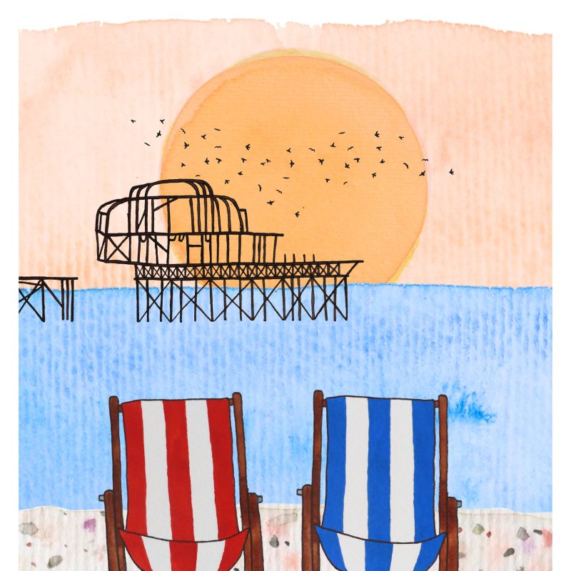 Deck chairs on Brighton beach with the West Pier at sunset