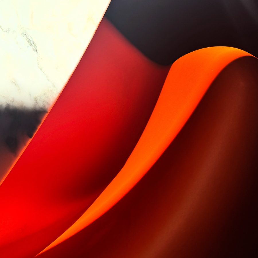 An abstraction of a white marble Eero Saarinen table and a red Verner Panton chair with fragments of sun and shade.