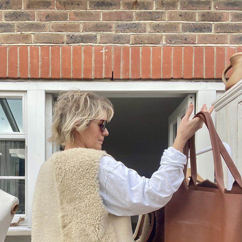 Rachel models one of her sheepskin waistcoats and tote bags