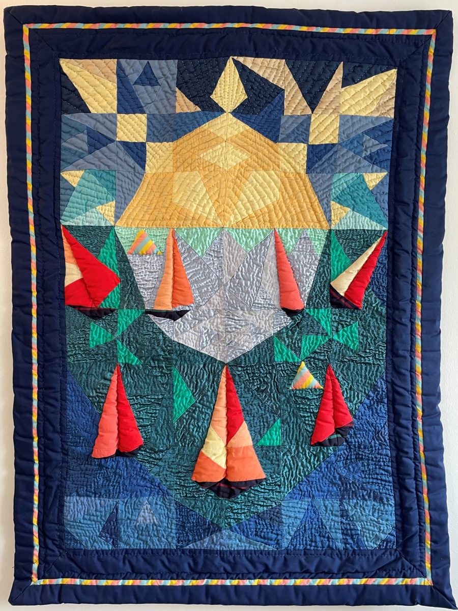 A textile picture of semi abstracted sailing boats on the sea with the sun behind them